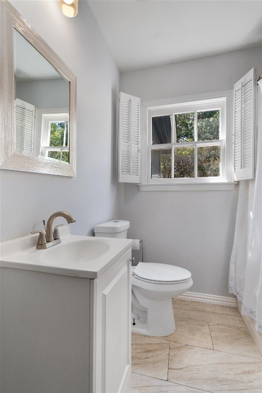 bathroom featuring vanity, toilet, and tile patterned floors