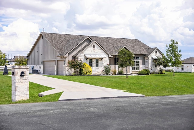 view of front of home with cooling unit, a garage, and a front yard