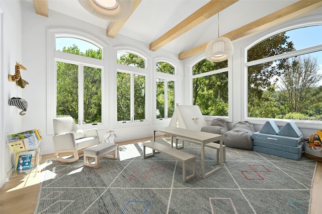 sunroom / solarium featuring lofted ceiling with beams