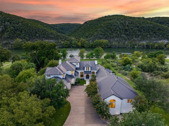 aerial view at dusk with a water and mountain view