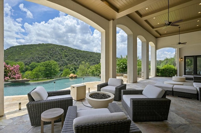 13414 Shore Vista Dr, Austin, TX 78732 - view of patio with a ceiling fan, an infinity pool, a wooded view, outdoor lounge area, and a mountain view
