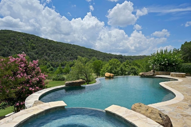 13414 Shore Vista Dr, Austin, TX 78732 - view of swimming pool featuring a wooded view and a pool with connected hot tub