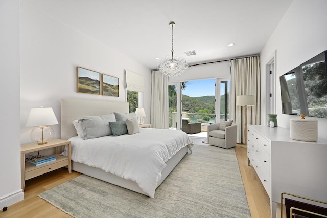 13414 Shore Vista Dr, Austin, TX 78732 - bedroom featuring light wood-type flooring, access to outside, a chandelier, and recessed lighting