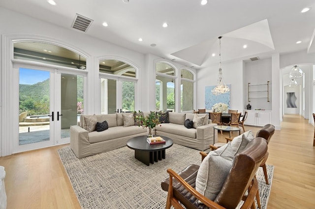 13414 Shore Vista Dr, Austin, TX 78732 - living area with french doors, light wood-type flooring, recessed lighting, a chandelier, and arched walkways