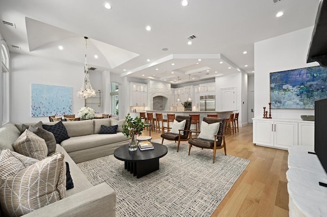 13414 Shore Vista Dr, Austin, TX 78732 - living area featuring light wood-type flooring, recessed lighting, a chandelier, and arched walkways