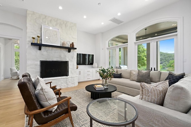 13414 Shore Vista Dr, Austin, TX 78732 - living area with light wood-style floors, recessed lighting, and a premium fireplace