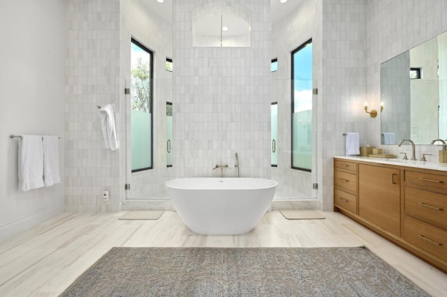 13414 Shore Vista Dr, Austin, TX 78732 - bathroom with tile walls, vanity, a freestanding tub, and a shower stall