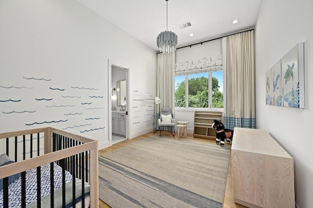 13414 Shore Vista Dr, Austin, TX 78732 - bedroom with light wood-type flooring, a nursery area, recessed lighting, and ensuite bath
