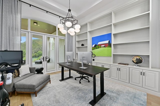 13414 Shore Vista Dr, Austin, TX 78732 - home office with built in shelves, french doors, light wood-type flooring, and a chandelier