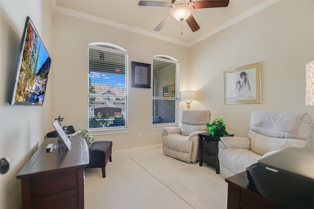 sitting room with light carpet, ornamental molding, and ceiling fan