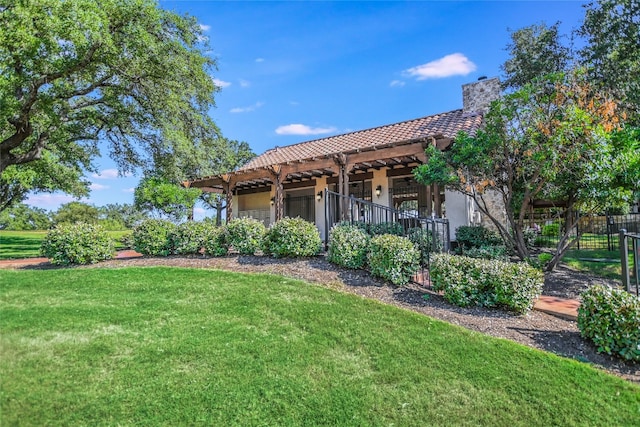 back of house with a yard and a pergola