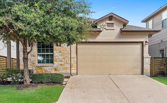 view of front of home with a garage, stone siding, concrete driveway, roof with shingles, and stucco siding