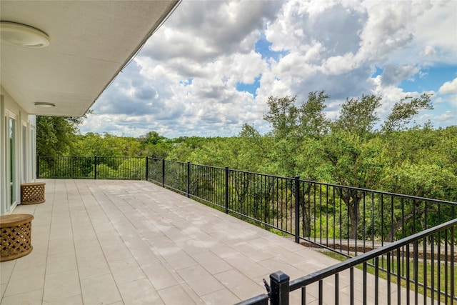 view of patio featuring a balcony