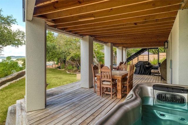 wooden deck featuring grilling area and a yard