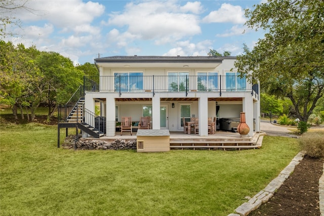 back of house with a balcony, a yard, a patio, and a deck