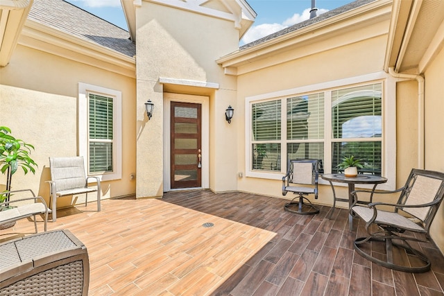 view of exterior entry featuring a wooden deck