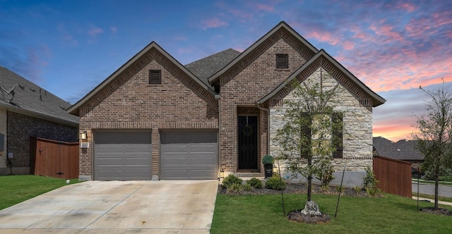 view of front facade with a garage and a lawn