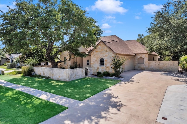 view of front facade featuring a garage and a front lawn