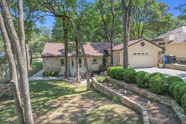 view of front of house with a front yard and a garage