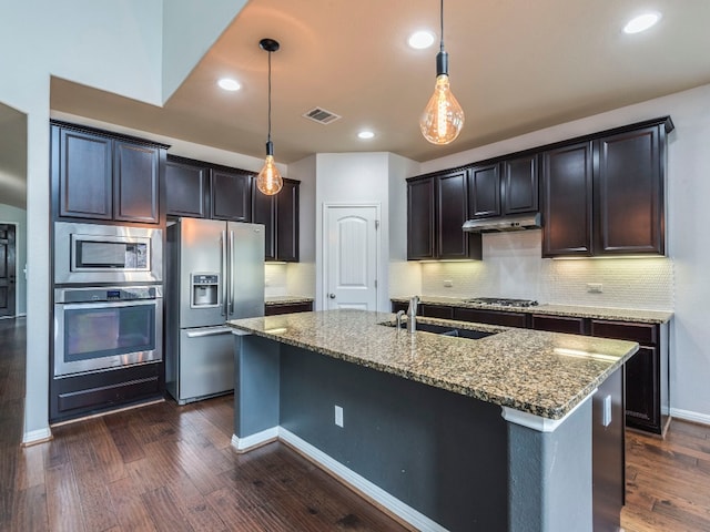 kitchen with stainless steel appliances, sink, dark wood-type flooring, pendant lighting, and tasteful backsplash