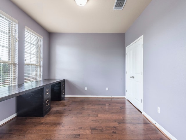 unfurnished office featuring dark hardwood / wood-style flooring