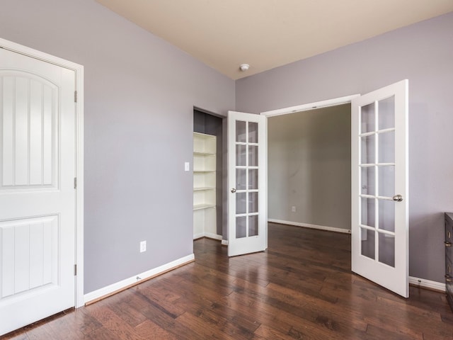 unfurnished room with dark wood-type flooring and french doors