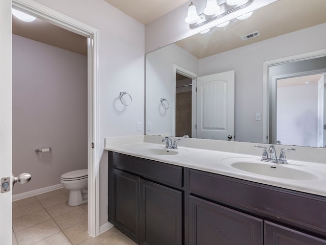 bathroom featuring tile patterned flooring, vanity, and toilet