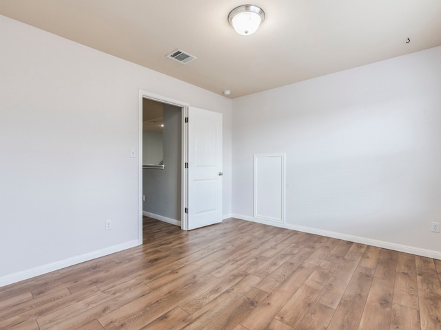 spare room with hardwood / wood-style flooring