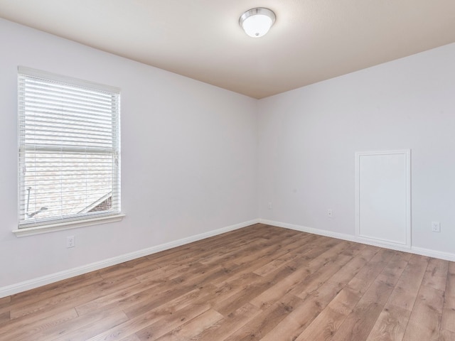 empty room with light hardwood / wood-style floors