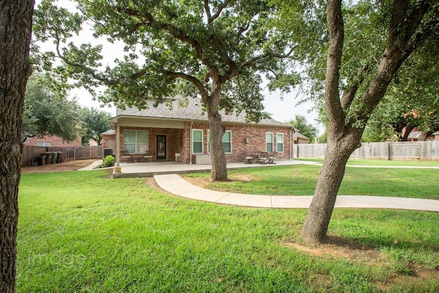 back of property featuring a lawn and a patio area