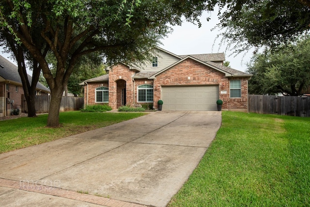 view of front of property with a front yard and a garage