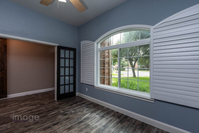 unfurnished room with vaulted ceiling and dark wood-type flooring