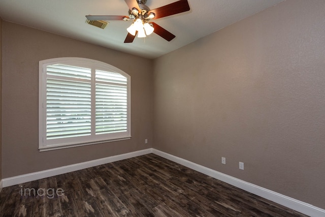 spare room featuring ceiling fan and dark hardwood / wood-style floors