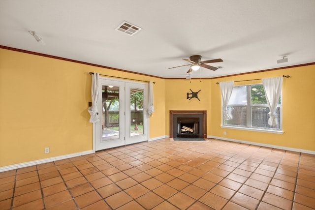 unfurnished living room featuring ceiling fan, ornamental molding, and light tile patterned flooring