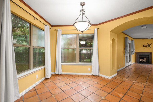 unfurnished dining area featuring crown molding and light tile patterned flooring