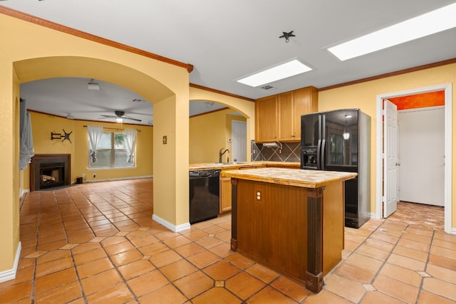 kitchen featuring a kitchen island, black appliances, light tile patterned floors, backsplash, and ceiling fan