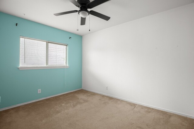 carpeted empty room with ceiling fan