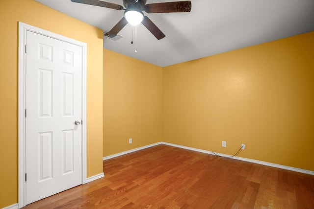 empty room featuring ceiling fan and hardwood / wood-style floors