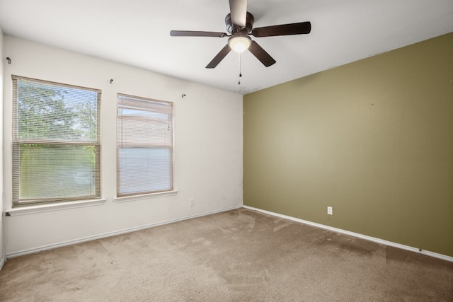 spare room with carpet and ceiling fan