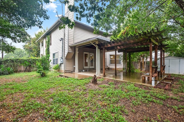 back of property with a pergola, a storage shed, and a patio