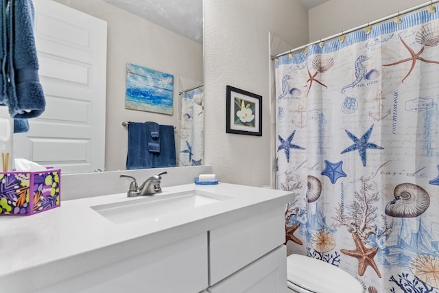 bathroom with a shower with shower curtain, toilet, and vanity