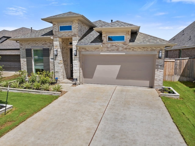 view of front facade featuring a garage and a front lawn