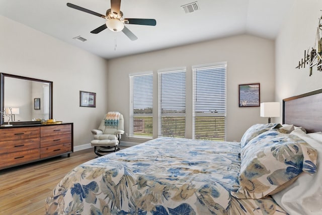 bedroom with ceiling fan, vaulted ceiling, and light hardwood / wood-style flooring