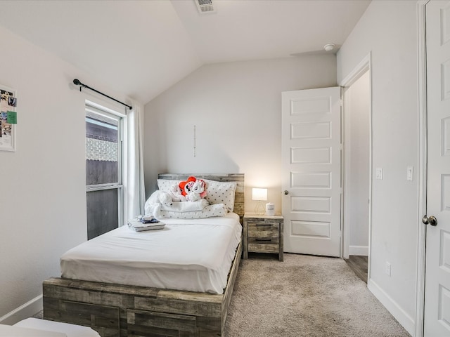 bedroom featuring lofted ceiling and light carpet