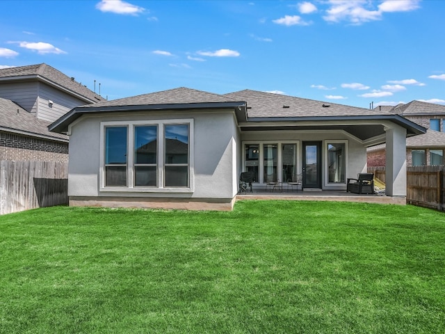 back of property featuring a yard and a patio