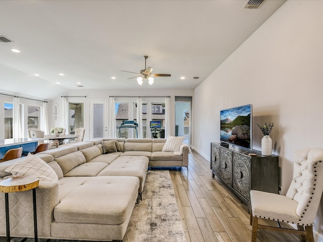 living room featuring ceiling fan and light wood-type flooring