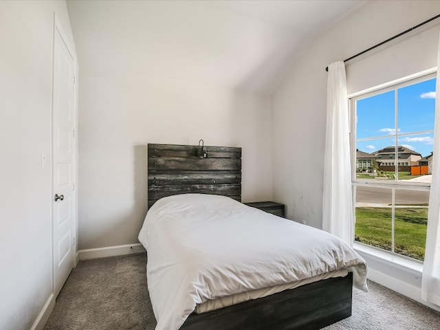 carpeted bedroom with vaulted ceiling