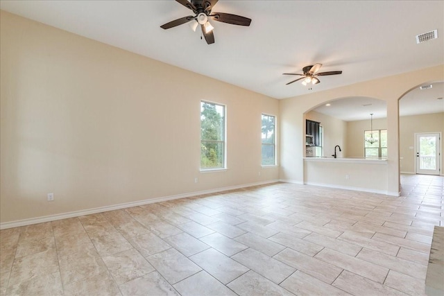 unfurnished room with ceiling fan and sink