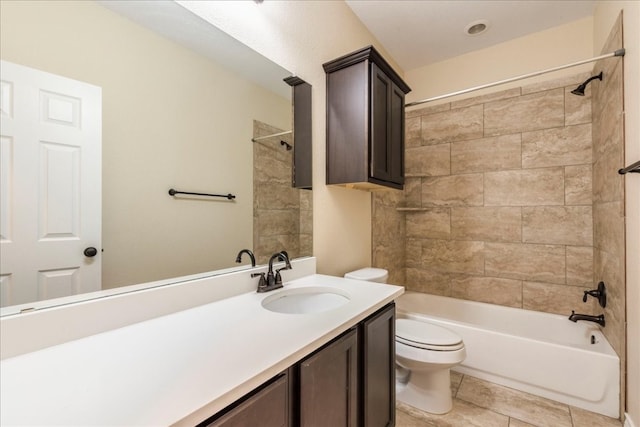 full bathroom with toilet, vanity, tile patterned floors, and tiled shower / bath