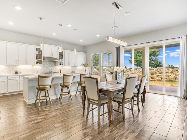 dining area featuring recessed lighting, visible vents, and light wood-style flooring